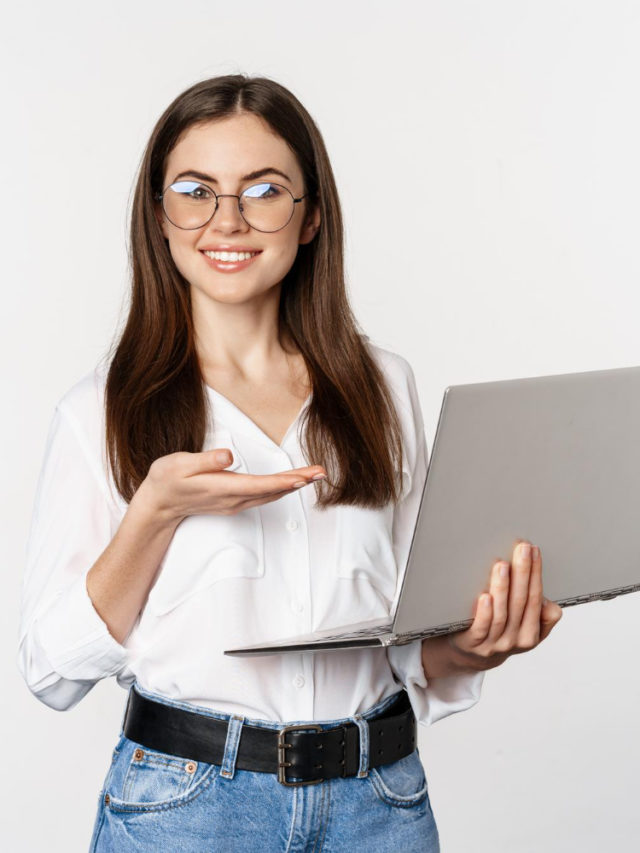 cropped portrait woman glasses holding laptop pointing screen showing her work computer standing 1