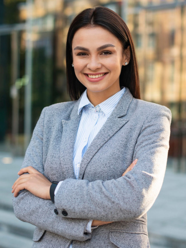 cropped smiley businesswoman posing outdoors with arms crossed copy space